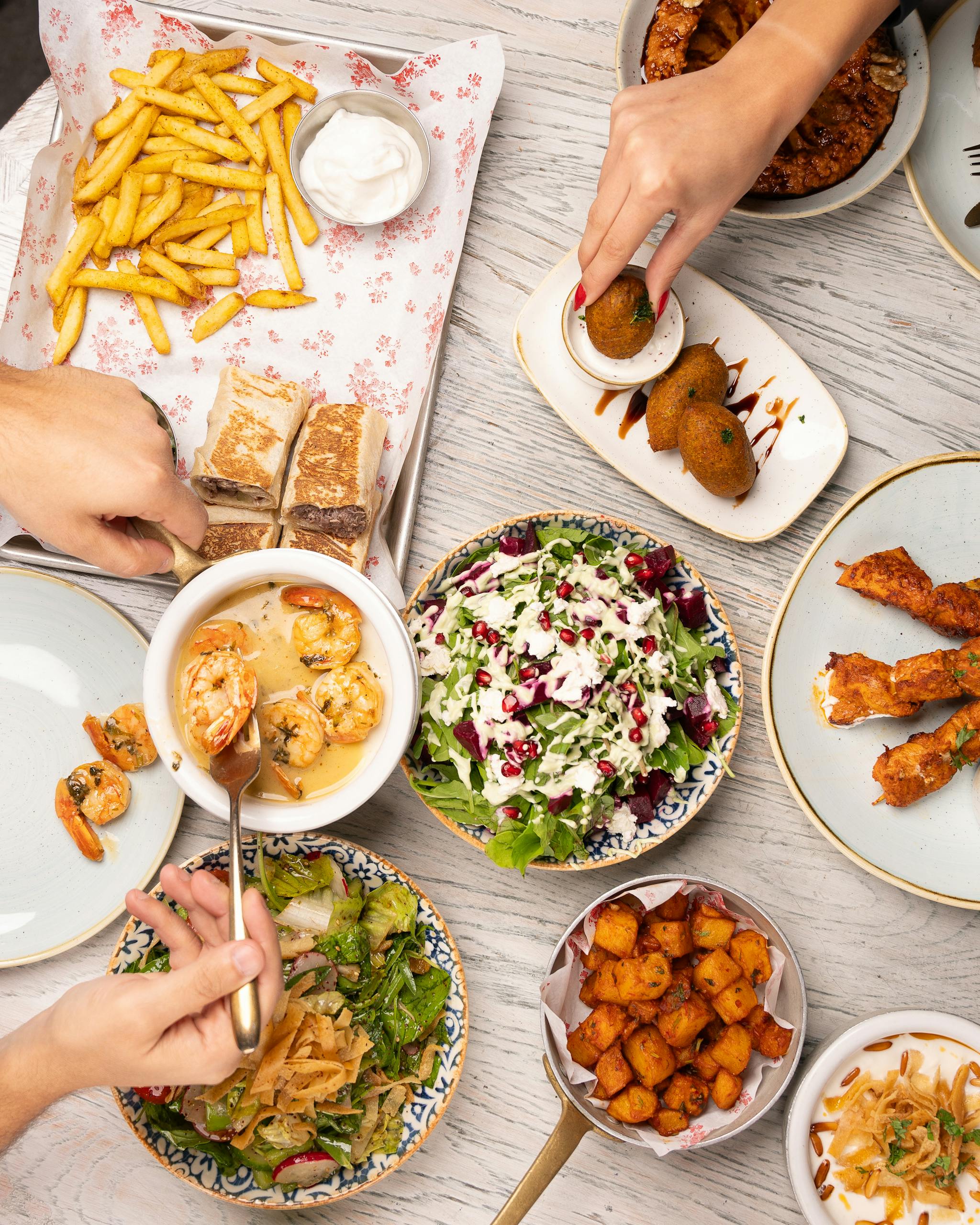 An inviting spread of Mediterranean cuisine featuring salads, seafood, and appetizers.