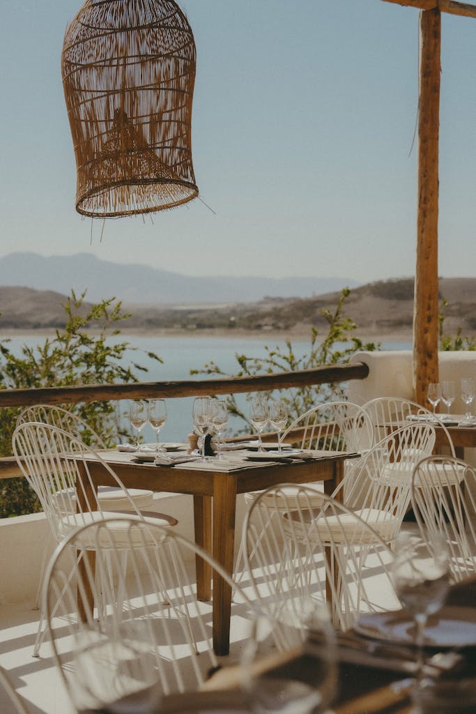 Charming outdoor cafe setting with river view in Marrakesh, ideal for a relaxing meal with a scenic backdrop.